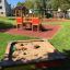 a sandpit and a play house on the playground
