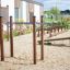 Outdoor fitness equipment Bars I in a sandy playground area.