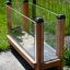 Vegetable garden wooden and glass elevated planter box near a fence