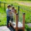 Children interacting with a Vegetable garden educational exhibit.