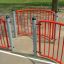 Red and grey Shea safety barriers on a playground.