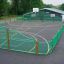 Multi-sport playground with green fences and basketball hoop from Shea.