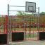Basketball hoop with red and black playground fence from Shea.