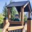 Child playing in the Country House Nature playground structure.
