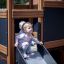 Children playing on Tower Nature wooden playhouse with slide.