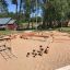 Outdoor playground equipment Jumping pegs in a sandy play area.