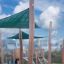 Sun Shade Triangle 5x5x5 Nature (Robinia) providing shade in a playground.