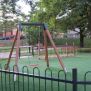 Wooden swing with safetyseat on playground