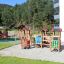 Alpha playhouse with slide in a playground setting