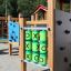 Alpha playhouse with slide and tic-tac-toe game on a playground.