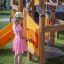 Child playing on Alpha playhouse with slide