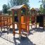 Alpha playhouse with slide in a sunny playground