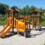 Alpha playhouse with slide in a playground on a sunny day