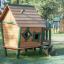 Wooden playhouse with green trim from Britta's Playhouse series.