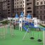 Double Tyre double swing on a playground with castle-themed structures.
