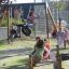 Children playing on Double Tyre double swing in a playground.