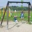 Double Safety Seat double swing with two children playing in a park