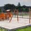 a wooden flat seat swing on the sand