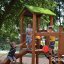 Children playing on the Triangle Modern Nature wooden playhouse with slide.