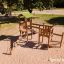 Triangle Modern Nature wooden playhouse with slide in a playground.