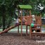 Triangle Modern Nature wooden playhouse with slide in a park setting