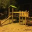 Triangle Modern Nature wooden playhouse with slide at night