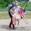 Family enjoying the Triple swing on a playground.