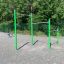 Metal Pull Bars for outdoor exercise at a playground with green poles and three different heights.