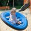 Two children sitting on a Swing Seat GBNS in a playground.
