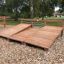 Sit-ups Bench made of wood in a park setting.