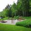 Outdoor gym with Sit-ups Bench in a forest setting.