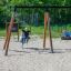 Children playing on Swing Frame 1(BNS) +1 (double swing) in playground.