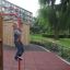 Child playing on Queen Jubilee playhouse with slide in a park.