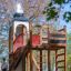 Alcazar playground castle with wooden structure and slide in park setting