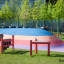 Outdoor Xylophone playground musical instrument on a colorful rubber surface.