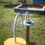 Playground equipment Rings with colorful circular platforms and a wavy metal rod for children to nav
