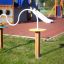 Playground equipment with a winding metal ring track and two wooden posts.