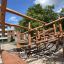 Sonora wooden playhouse climbing frame with net bridge.