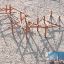 Sonora playground climbing structure with wooden beams on sand surface.
