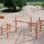 Sonora wooden playhouse in a spacious sandy playground.