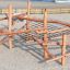 Sonora wooden playground climbing structure with netting on sand surface.
