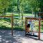 Trim Trail Nature II wooden climbing playground equipment with children playing outdoors