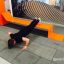 Man exercising on the Ribbon Fitness II outdoor fitness bench.