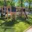 Outdoor playground equipment Challenger Nature II set on artificial grass.