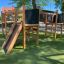 Wooden playground structure Challenger Nature II with slide and climbing elements.