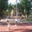 Children playing on a pyramid-shaped climbing net in a park with Rubber Tiles 35 flooring.