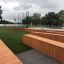 Wooden benches at Multiarena Wooden in outdoor recreational area.