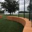 Wooden benches in Multiarena Wooden sports facility near a lake.