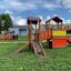 an outdoor play area with a playground locomotive