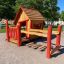 red wooden playhouse with fencing
